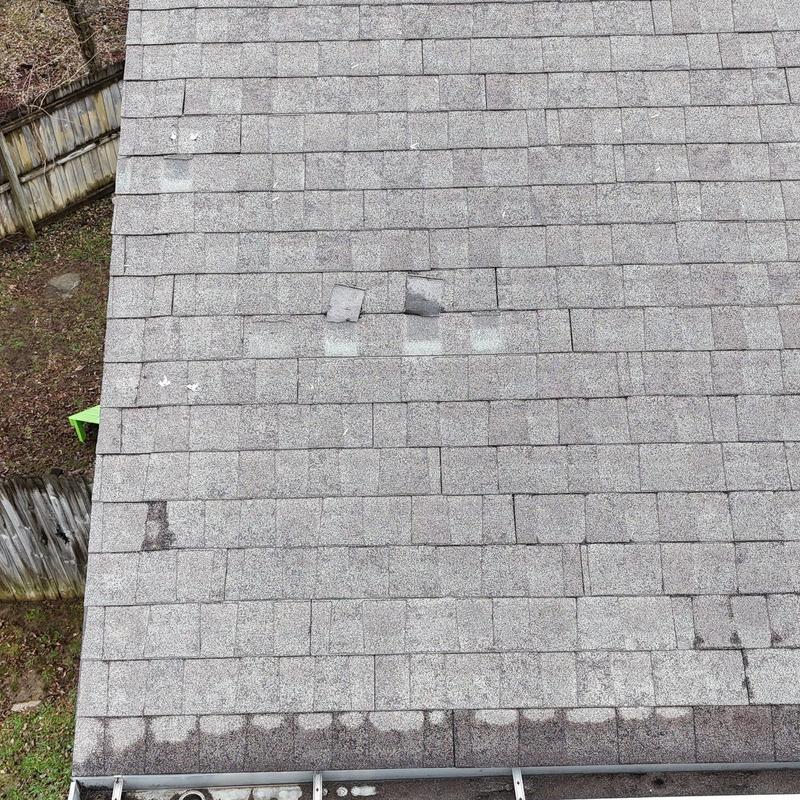 Roof shingles with visible hail damage on multiple slopes