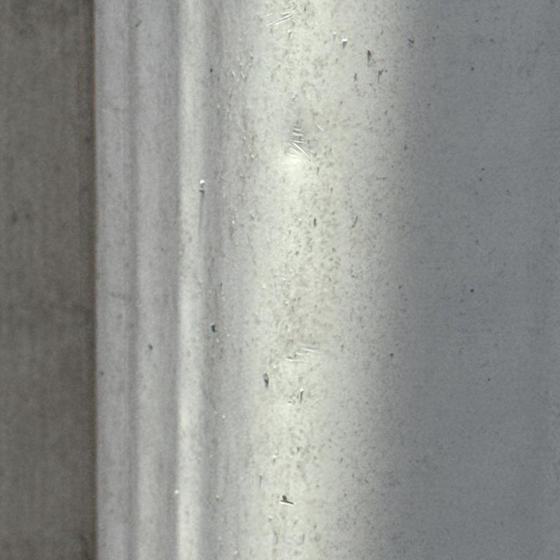 Metal roofing panel with hail impact dents close-up