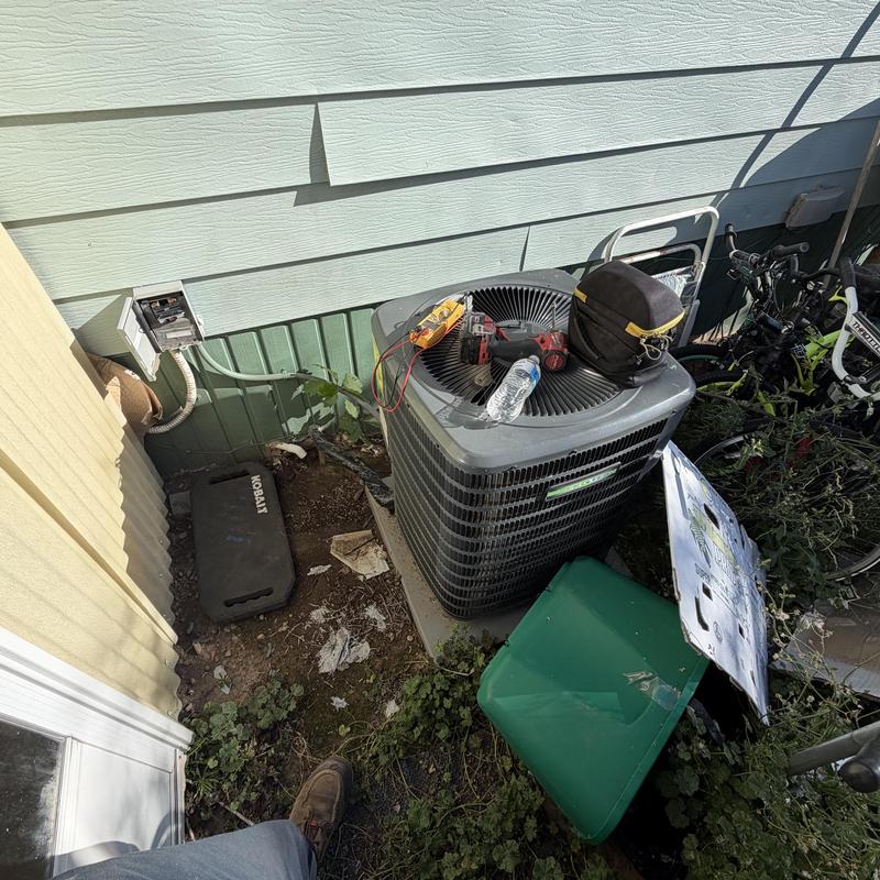 Air conditioner outdoor unit with tools on top Air conditioner outdoor unit with tools on top