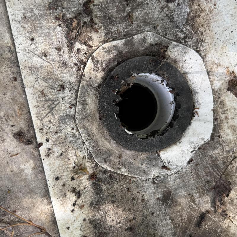 TPO roof drain with damaged flashing and debris TPO roof drain with damaged flashing and debris