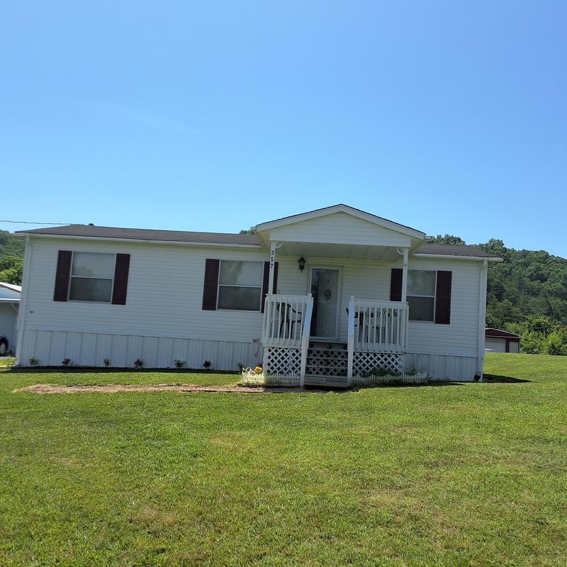 Mobile home roof inspection with porch and lawn view Mobile home roof inspection with porch and lawn view