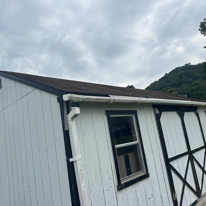 Outbuilding shingle roof with white siding and gutters Outbuilding shingle roof with white siding and gutters