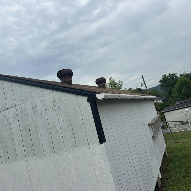 Residential shingle roof with turbine vents on outbuilding Residential shingle roof with turbine vents on outbuilding