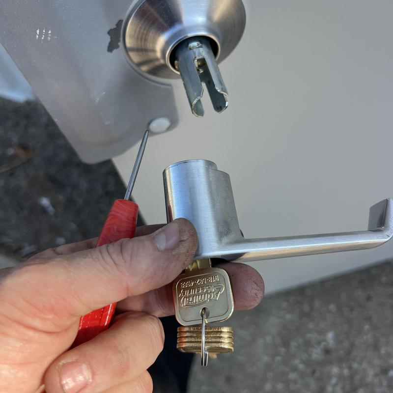 Door lever lock rekeying with key and tool