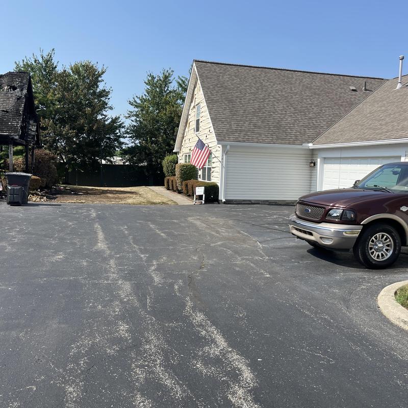 Burned roof shingles on residential house exterior Burned roof shingles on residential house exterior