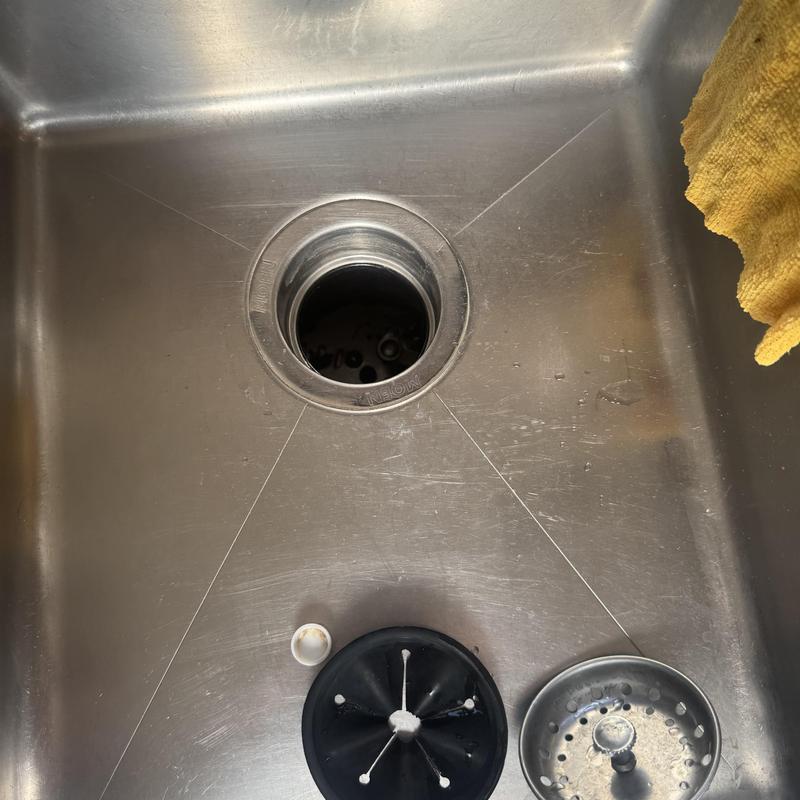 kitchen sink drain opening with removed disposal parts