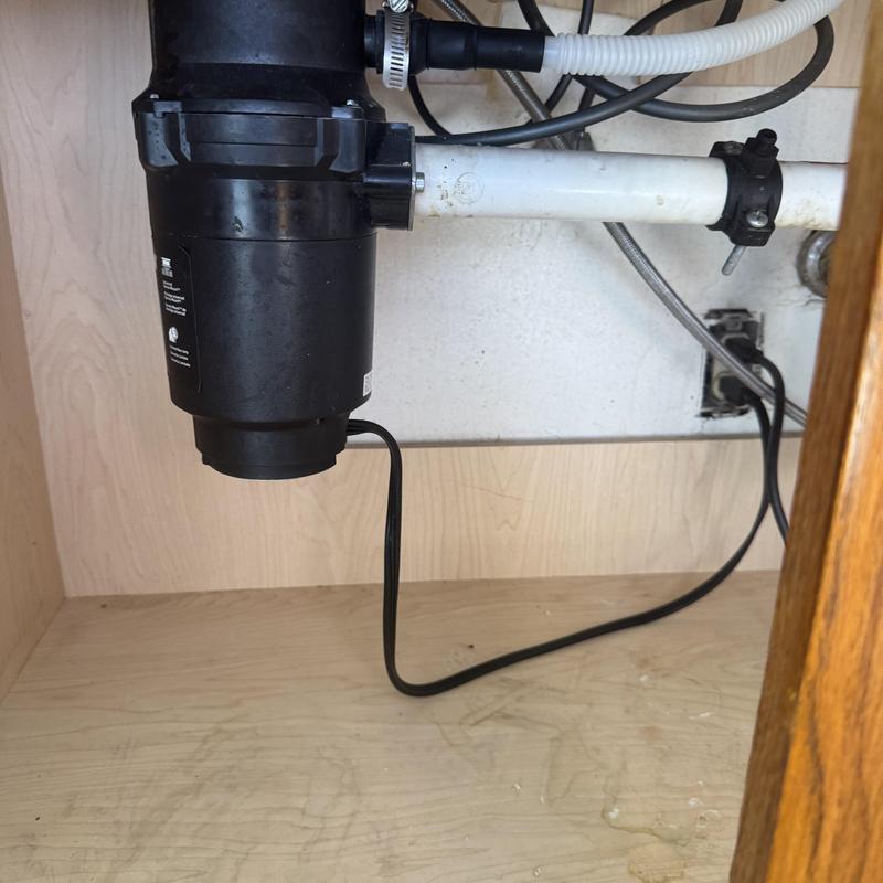 Garbage disposal and sink drain plumbing under cabinet