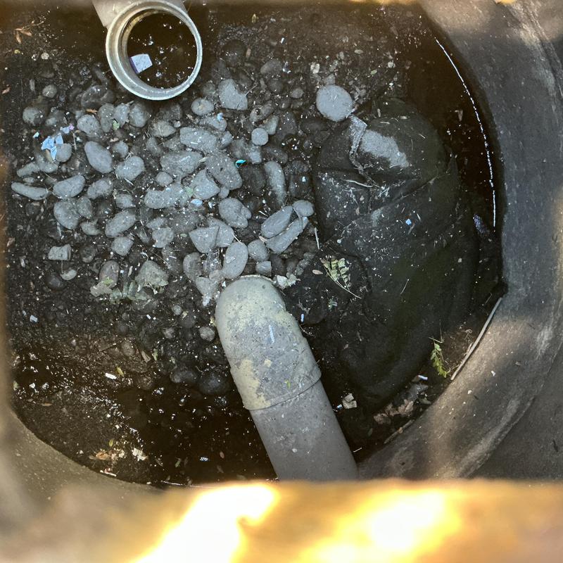 Sewer cleanout pipe with gravel and debris inside Sewer cleanout pipe with gravel and debris inside
