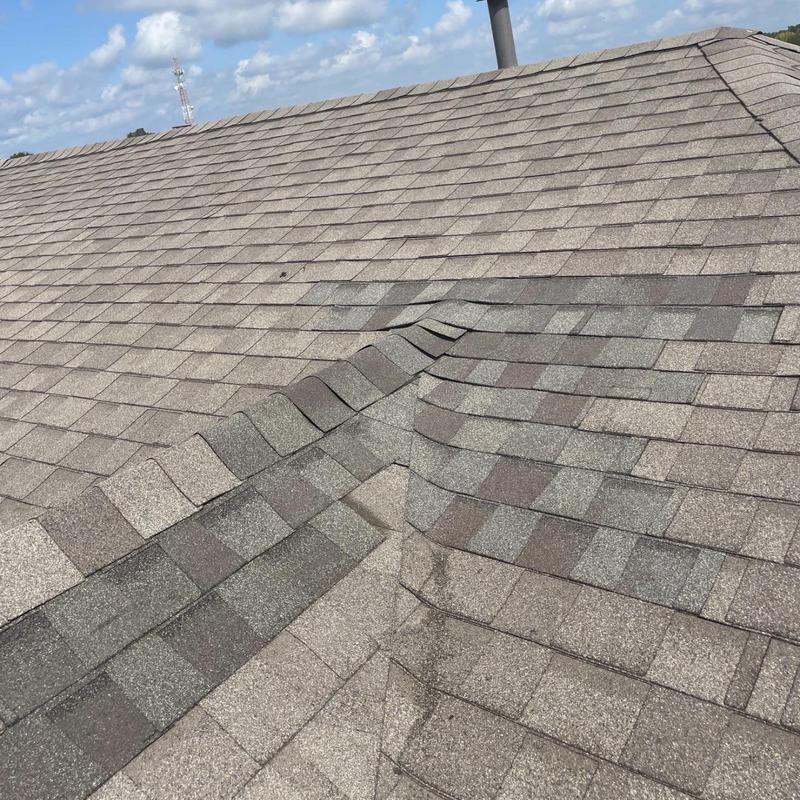 Asphalt shingle roof valley with repaired shingles