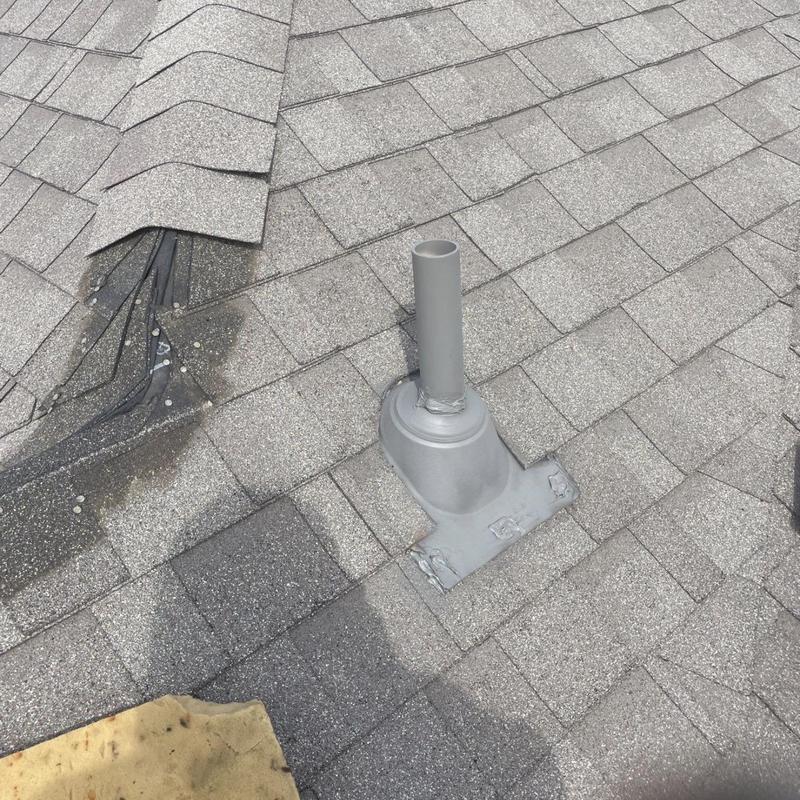 Asphalt shingle roof with pipe boot installation