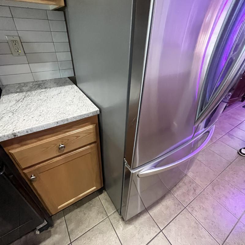 Stainless steel refrigerator next to kitchen countertop Stainless steel refrigerator next to kitchen countertop
