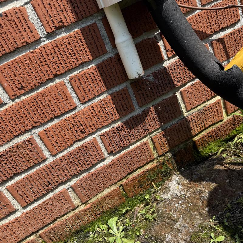 AC condensate drain pipe clearing on brick wall AC condensate drain pipe clearing on brick wall