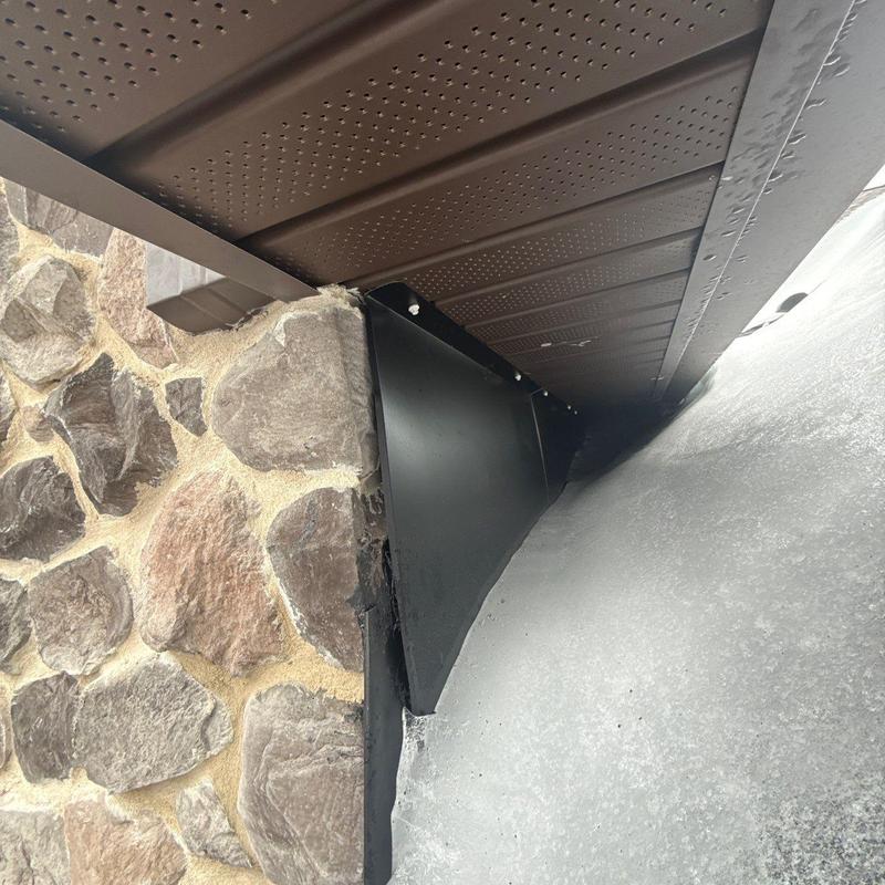 Roof flashing installation on stone exterior wall