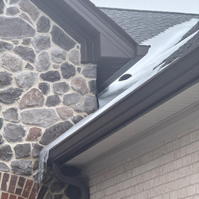 Roof gutter with ice buildup on residential home