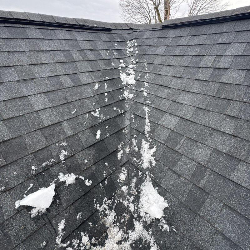 Roof shingles with hail damage and ice patches