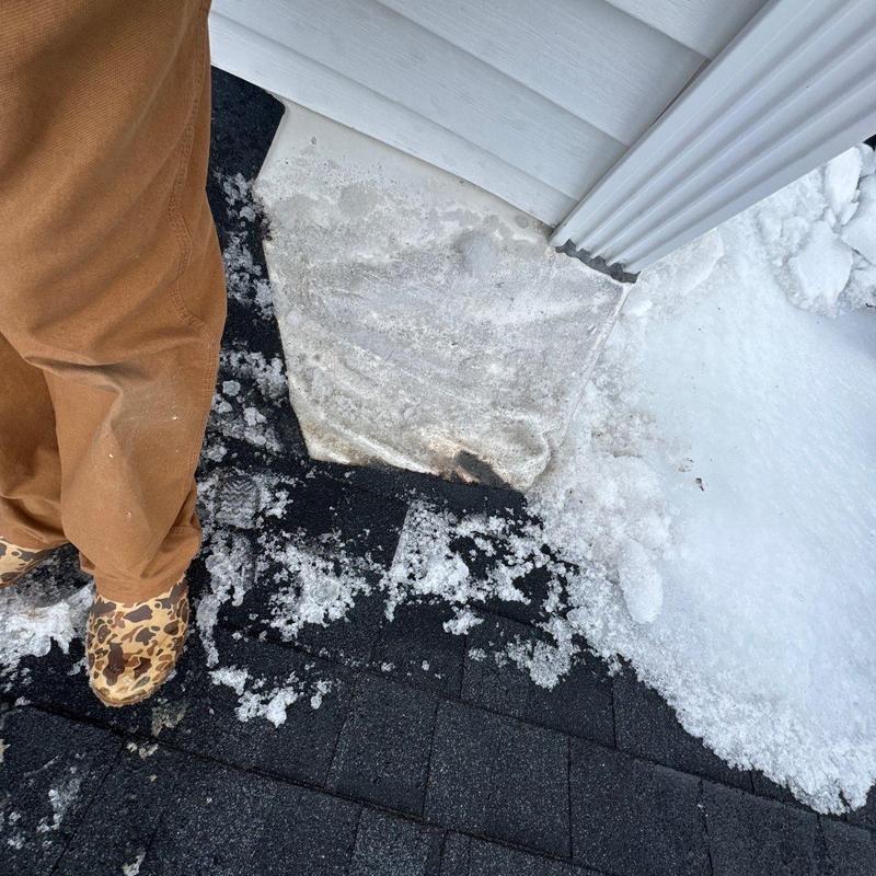 Roof shingles with hail damage and ice accumulation