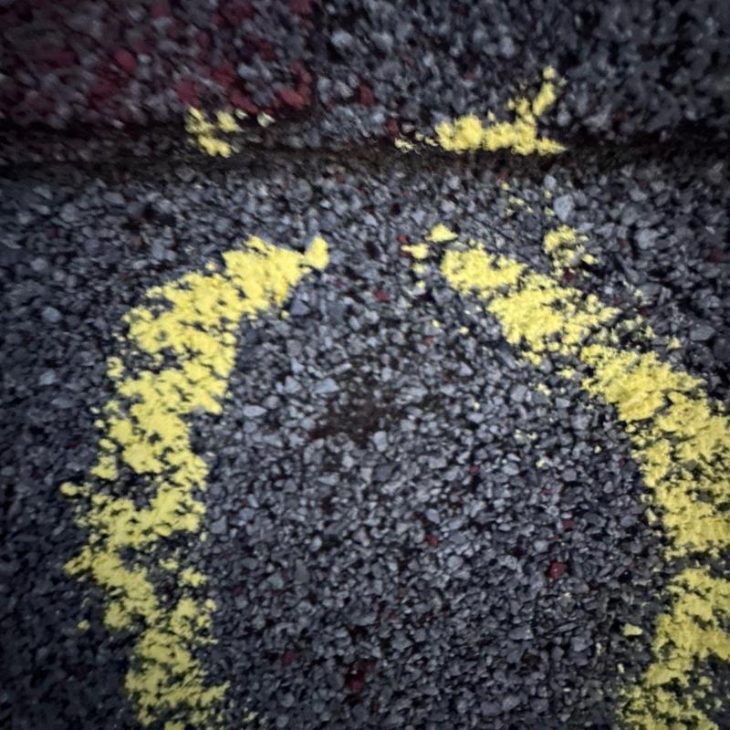 Asphalt roof shingle hail damage marked with yellow paint