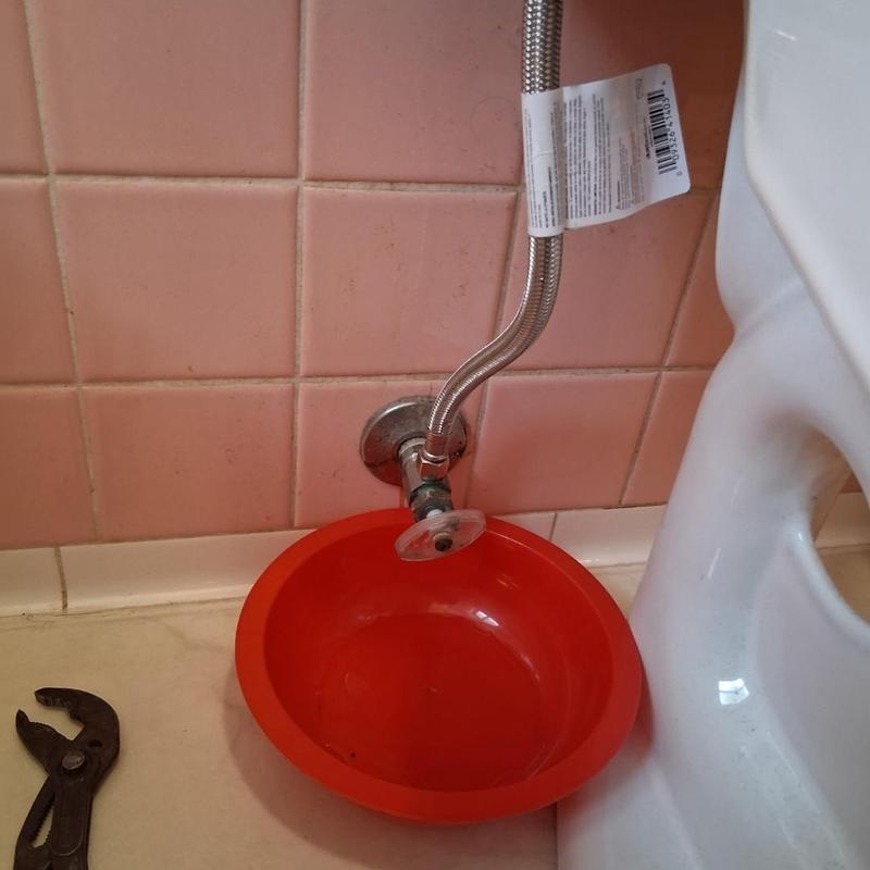 Stop valve rebuild with red catch basin and wrench