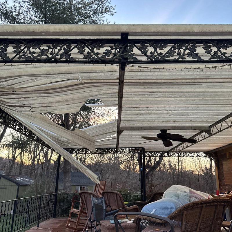 Retractable patio awning with torn fabric panels