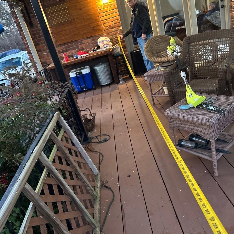 Wood deck measuring with tape for repair evaluation