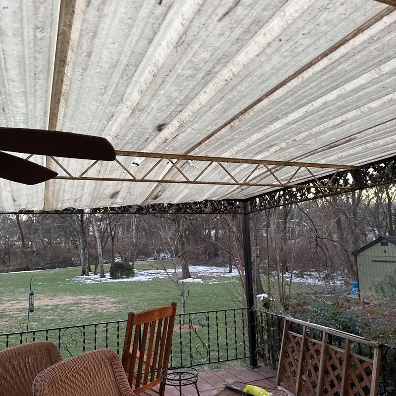 Metal patio roof with lattice trim and outdoor seating