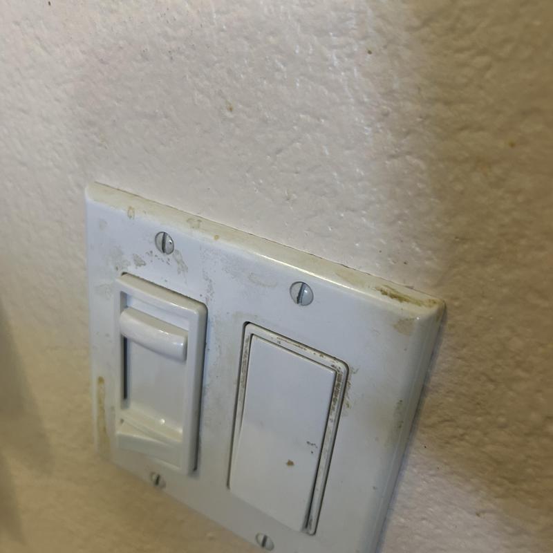 Dimmer switch and rocker light switch on wall