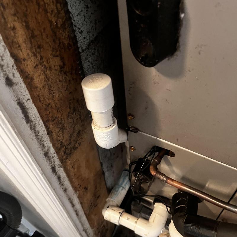 PVC condensate P-trap with glued joints near HVAC unit