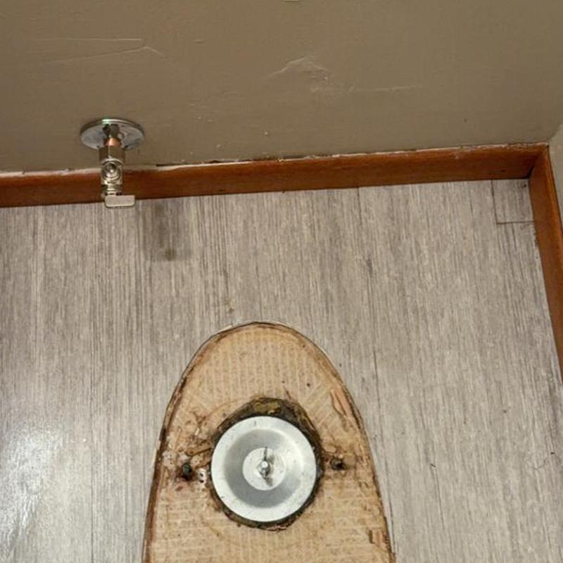 Toilet flange on vinyl floor with water supply valve Toilet flange on vinyl floor with water supply valve