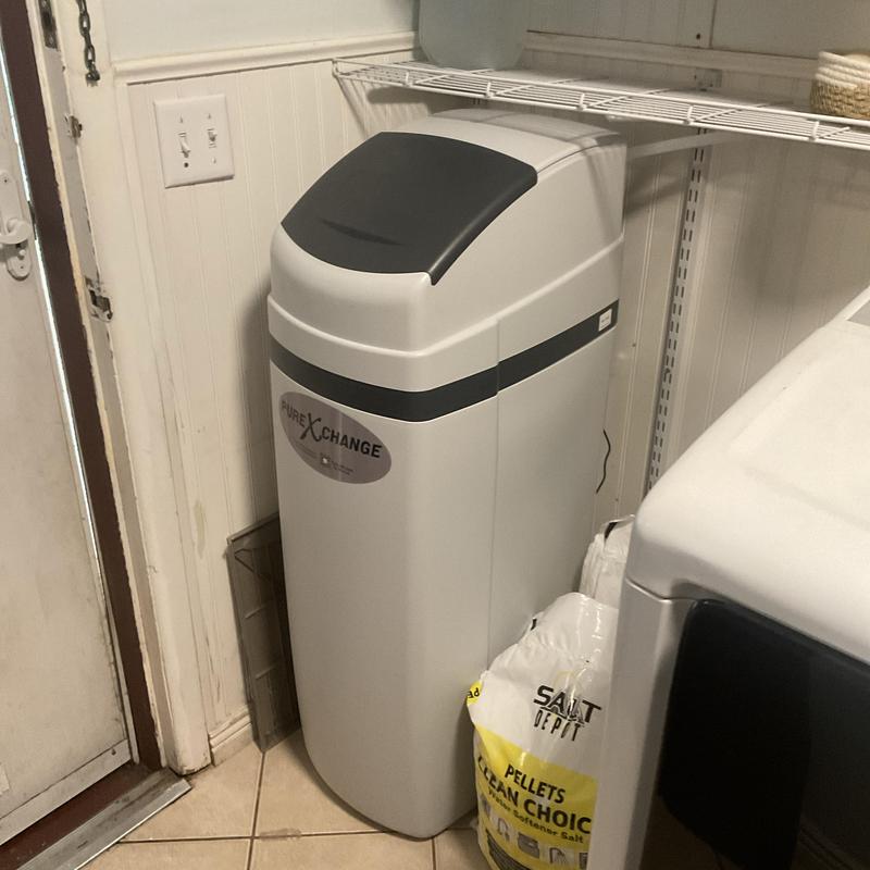 Water softener system installed with salt pellets nearby Water softener system installed with salt pellets nearby