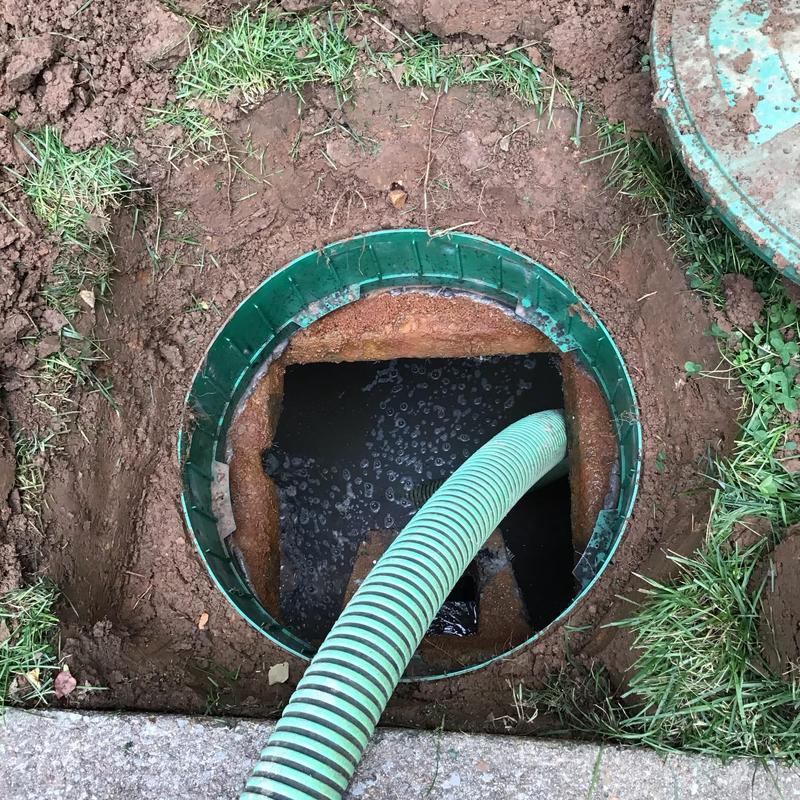 Septic tank with pump hose at residential property Septic tank with pump hose at residential property