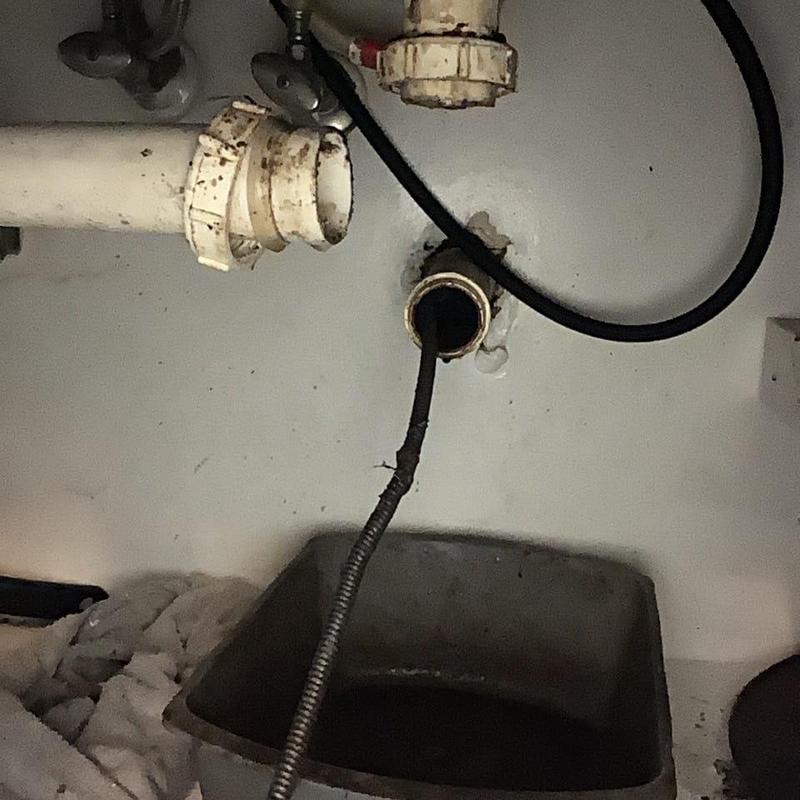 Kitchen sink drain line with cleaning snake tool Kitchen sink drain line with cleaning snake tool