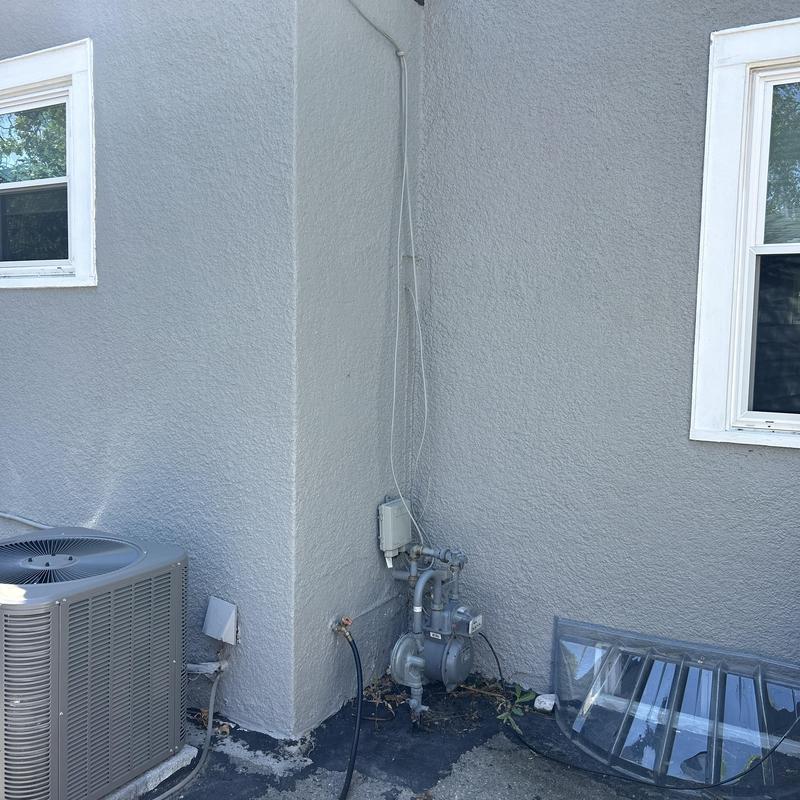 Gas meter and regulator installed on exterior wall