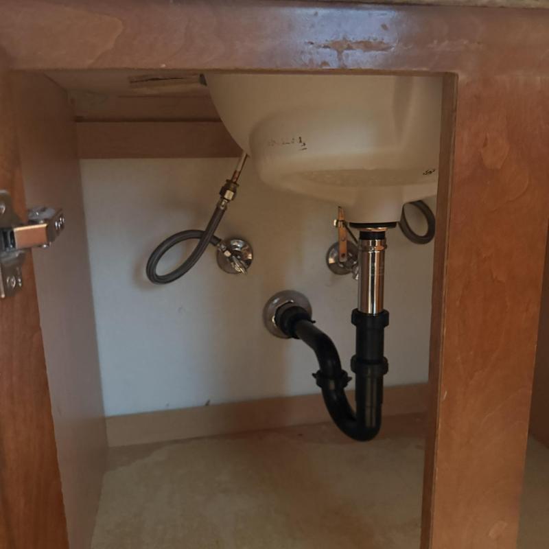 Pop-up drain assembly under bathroom sink cabinet
