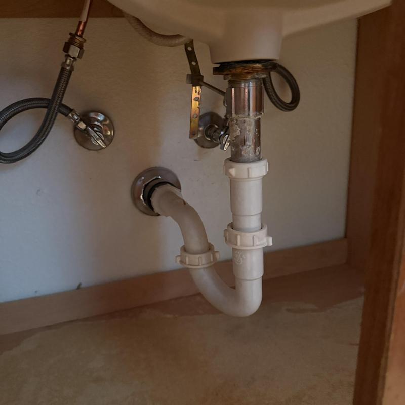 Sink pop-up drain assembly and plumbing lines under cabinet
