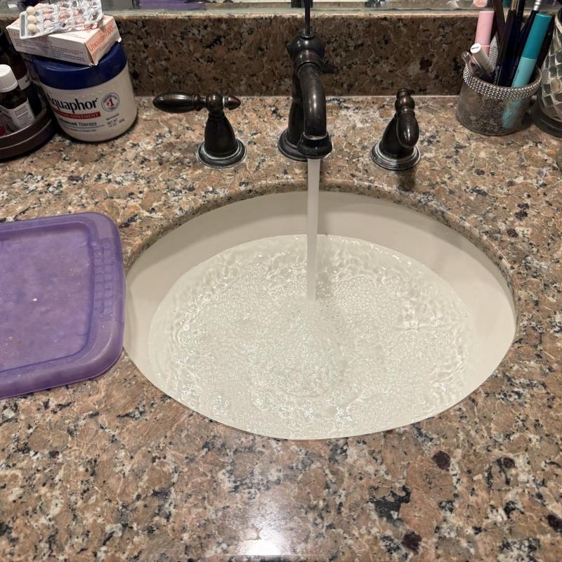 Bathroom sink pop-up drain assembly with running water