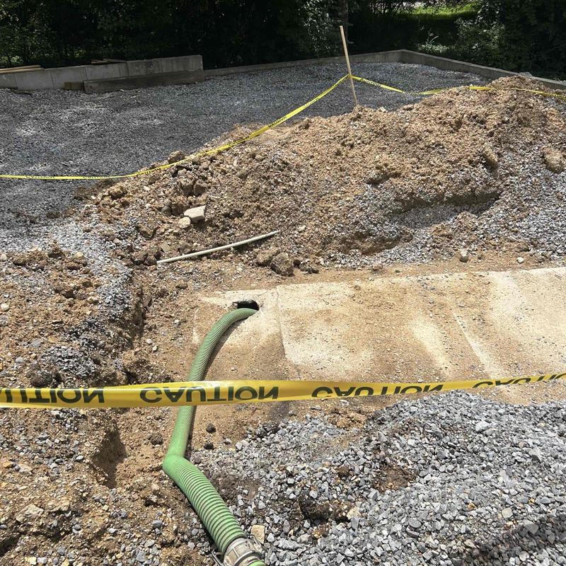 Septic tank riser with green pumping hose Septic tank riser with green pumping hose