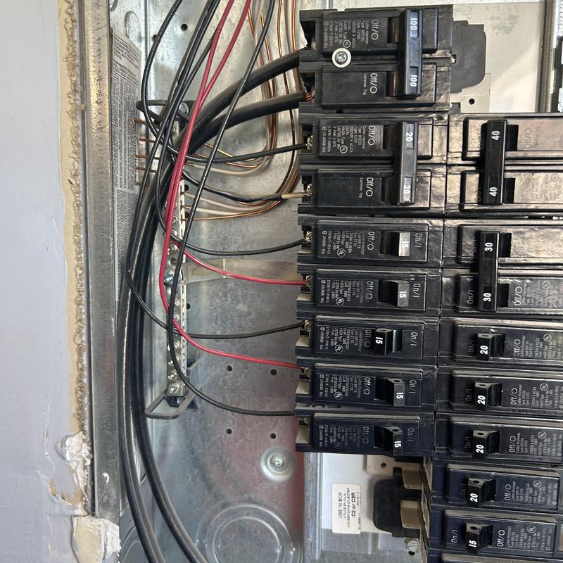 Circuit breaker panel with wiring connections in wall