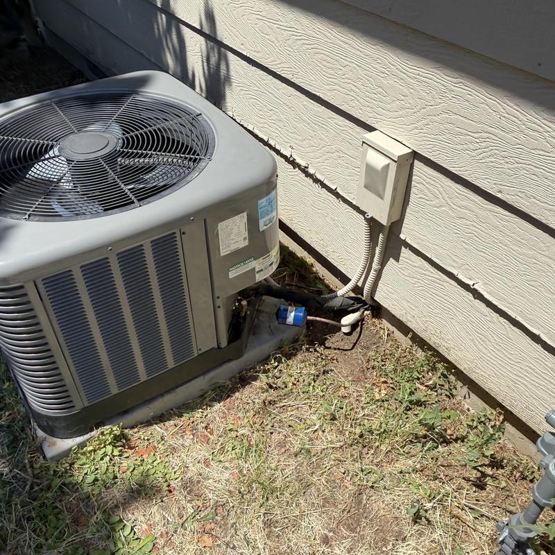 Ruud 2-ton AC condenser unit outside home Ruud 2-ton AC condenser unit outside home