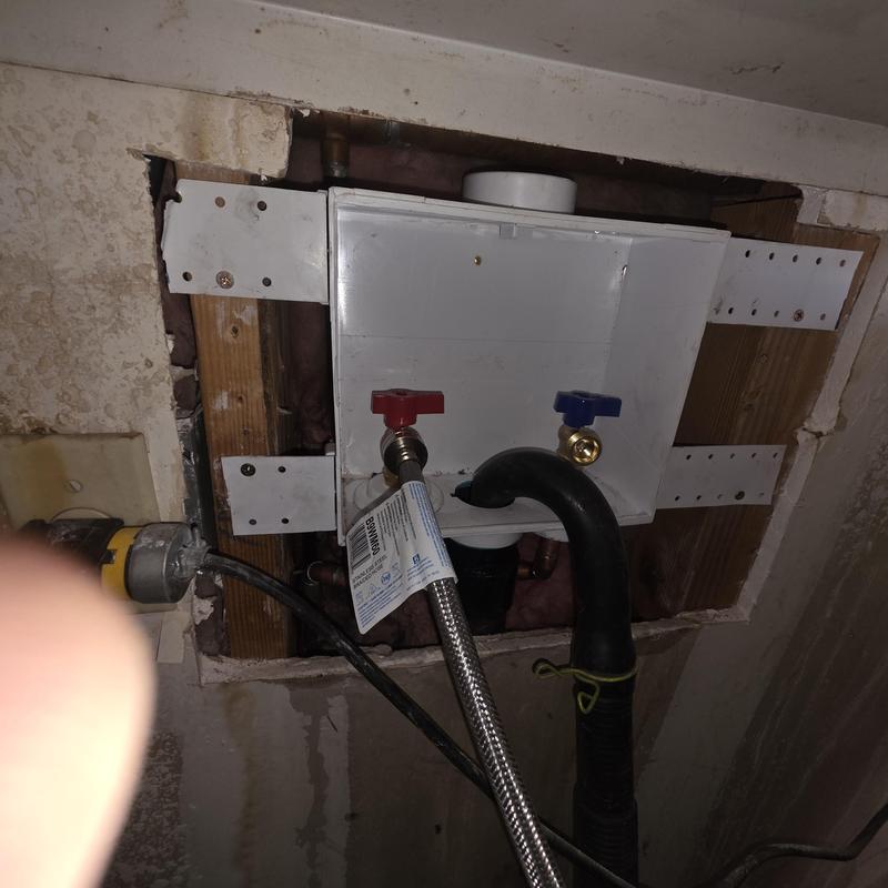 Washer box with red and blue water valves installed