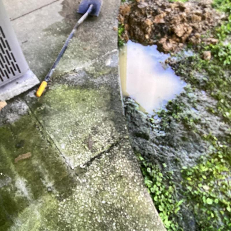 Water line leak at muddy outdoor yard edge Water line leak at muddy outdoor yard edge