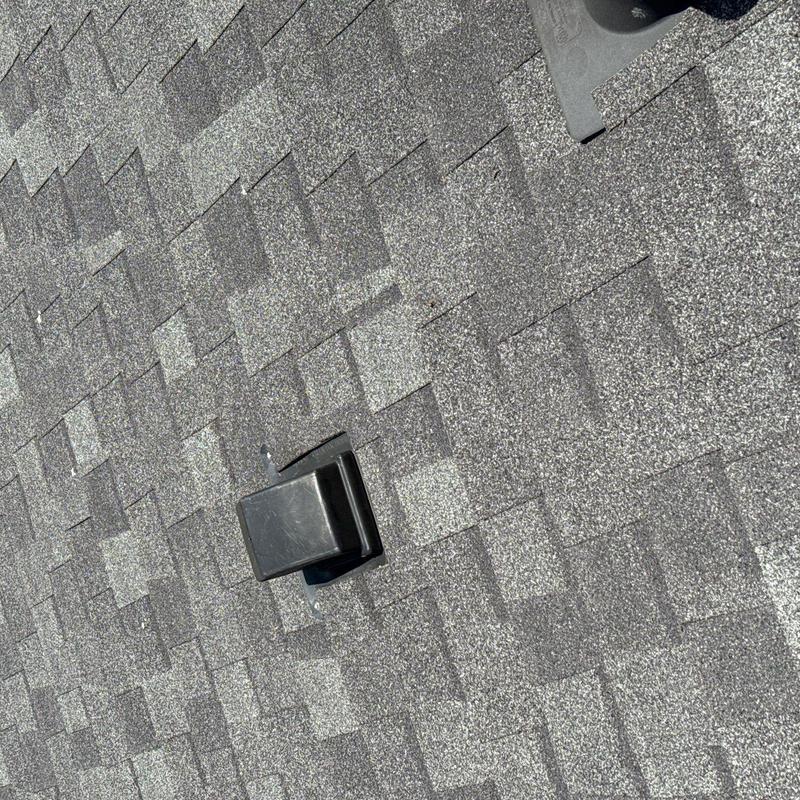 Asphalt shingle roof with ventilation cap installation