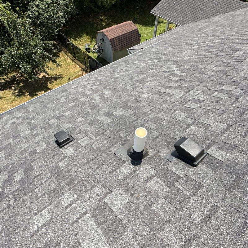 Asphalt shingle roof with vent pipes and ridges