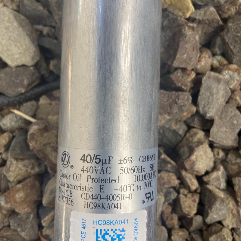 Condenser capacitor label on gravel background Condenser capacitor label on gravel background
