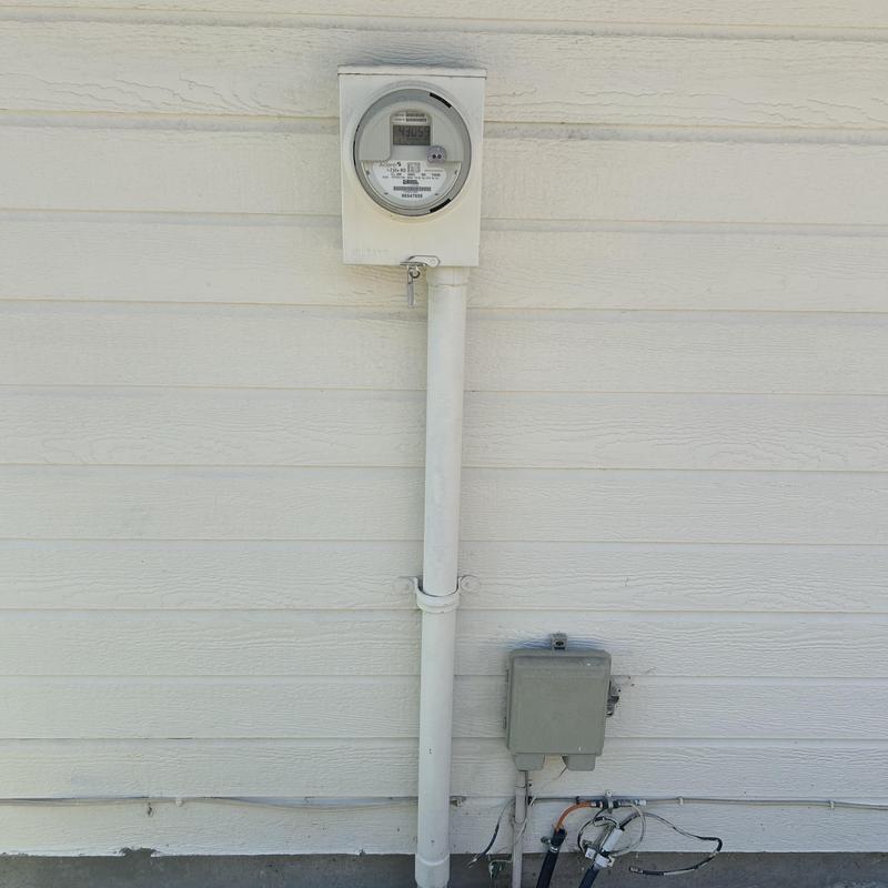 Electric meter and internet wiring outside home wall Electric meter and internet wiring outside home wall