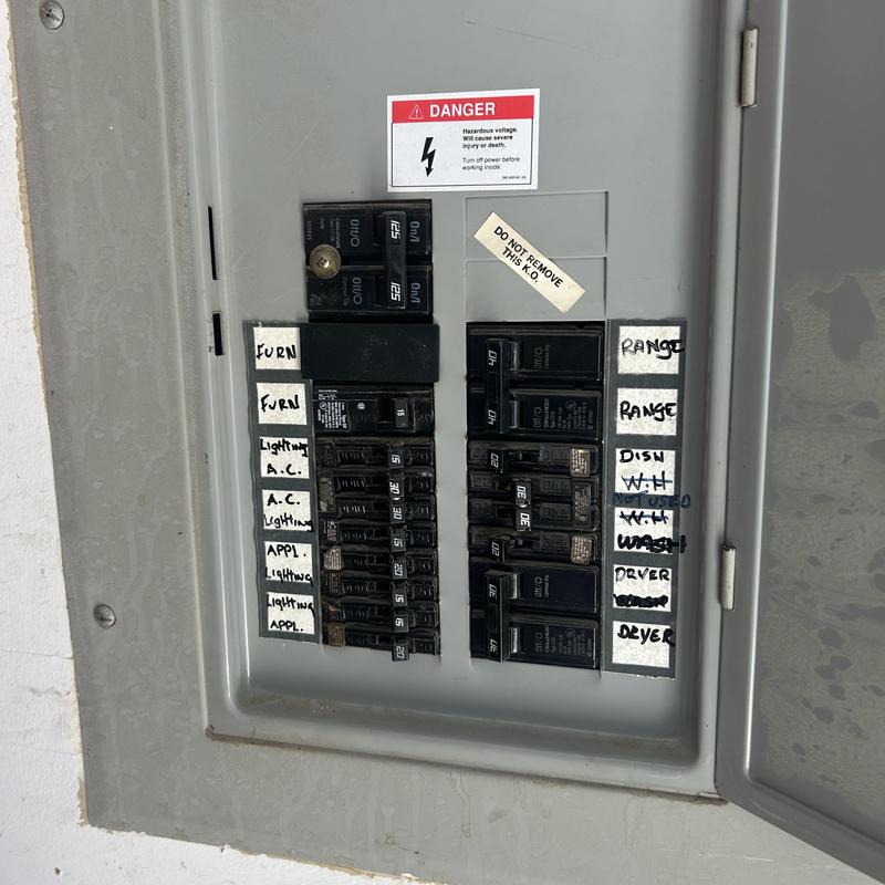 Main electrical panel with labeled circuit breakers Main electrical panel with labeled circuit breakers