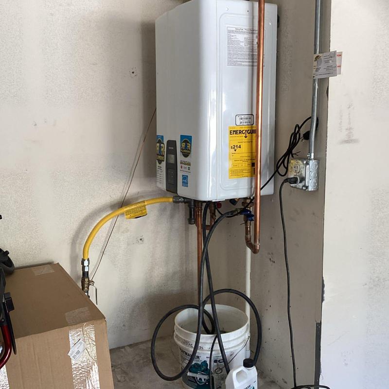 Tankless water heater with flush setup and bucket