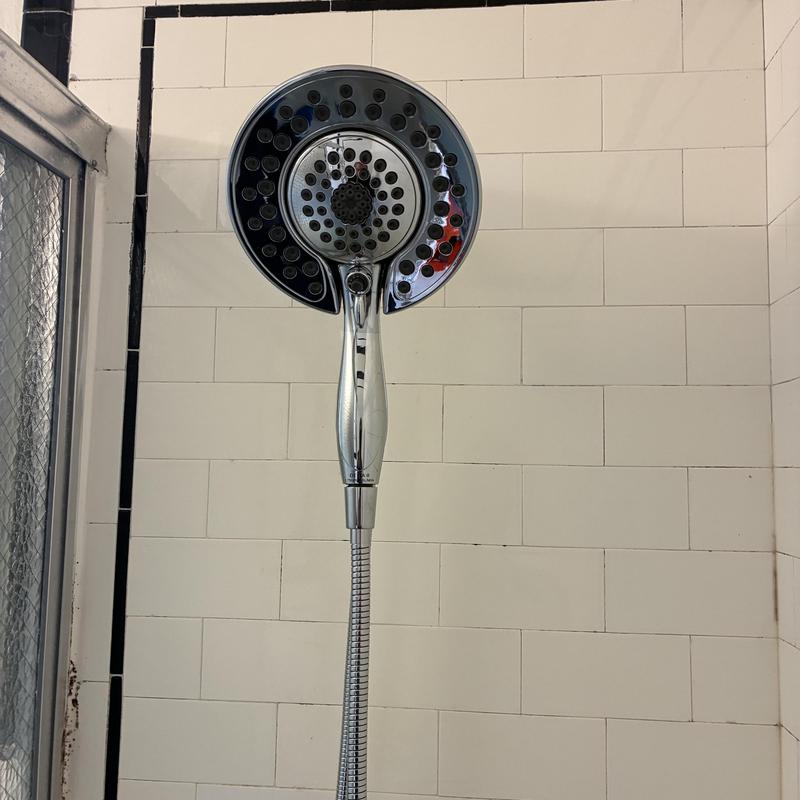 Handheld shower head installation in tiled shower wall