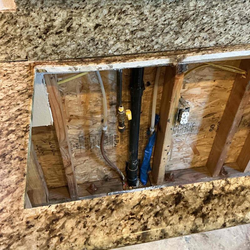 Copper hot water line capped in kitchen island countertop