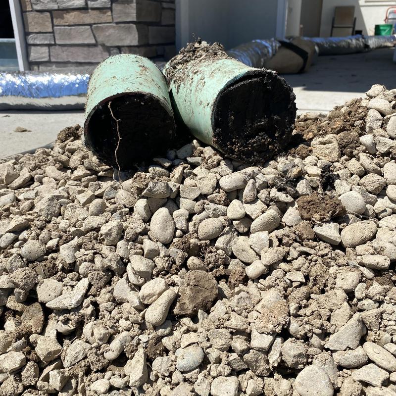 French drain pipes clogged with soil and debris buildup French drain pipes clogged with soil and debris buildup