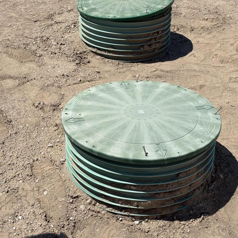 Aerobic treatment unit septic tank lids on dirt ground Aerobic treatment unit septic tank lids on dirt ground